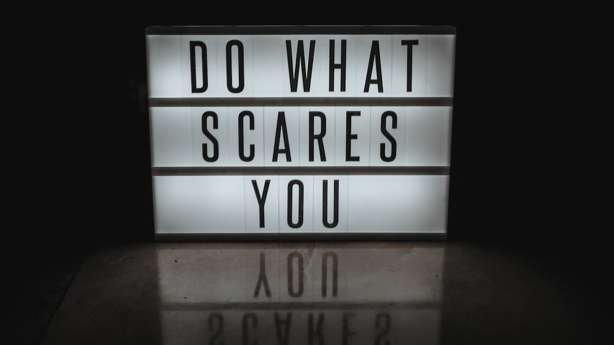 a lighted sign that says do what scared you